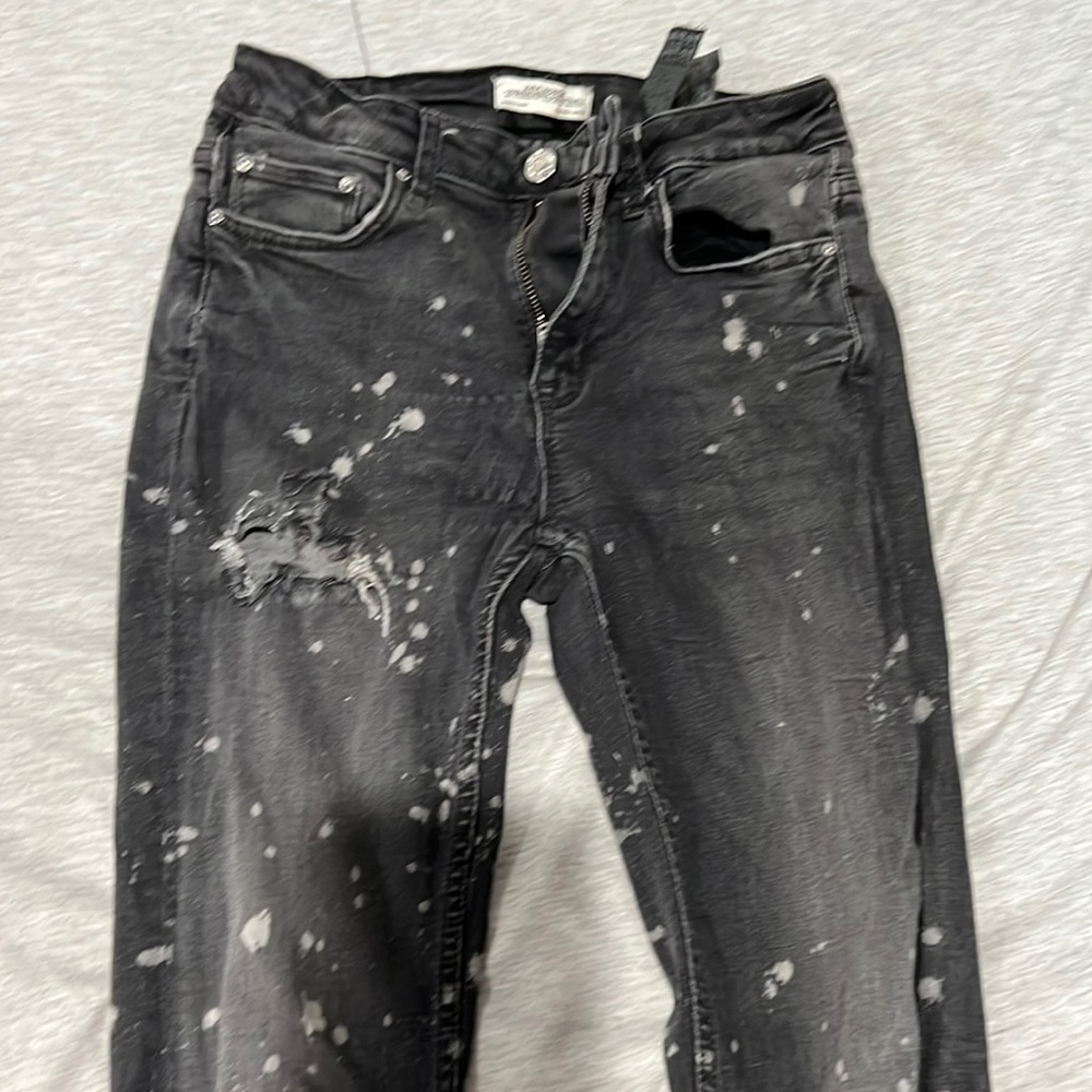 Black and grey tight fitted splat jeans